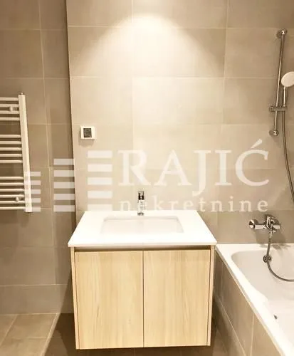 Modern bathroom with a sink and bathtub.