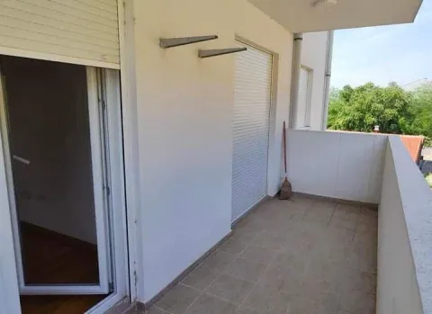 Spacious balcony with tiled floor and balcony doors. - image 9