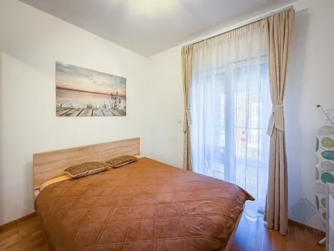 Furnished bedroom with a double bed and balcony access. - image 6