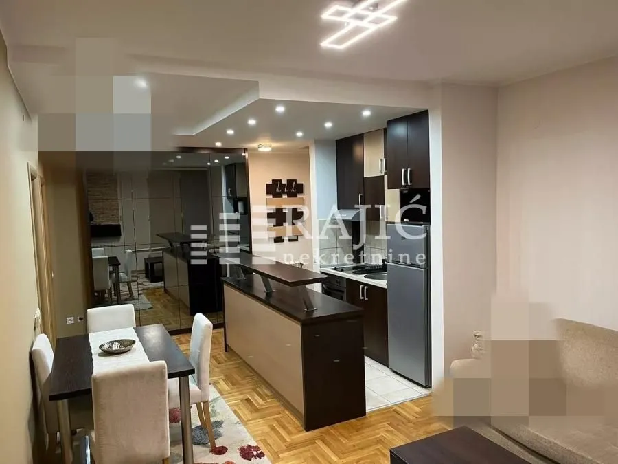 Living room with dining area and kitchen in an open plan layout.