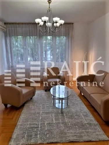Living room with seating set, coffee table, and chandelier.