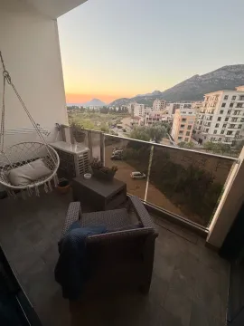 Furnished terrace with an armchair and views of the city and mountains. - image 7