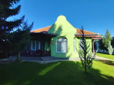 View of the front facade of the house and landscaped yard with greenery. - image 14