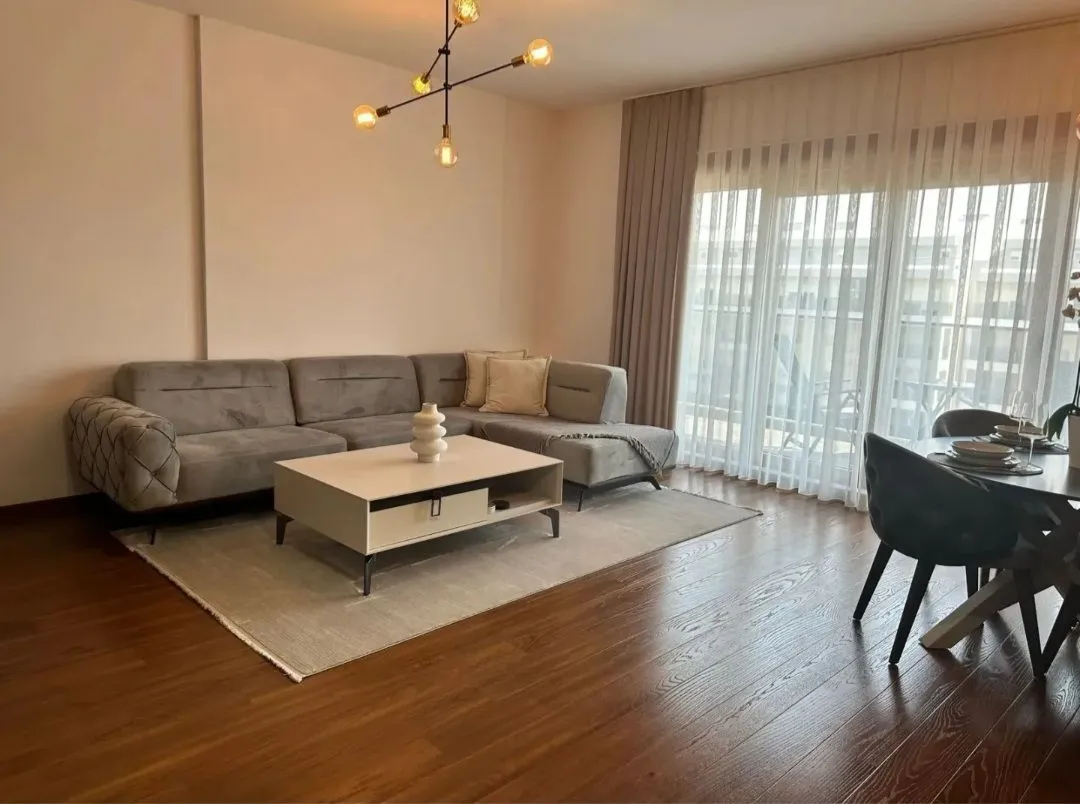 Spacious living room with a sectional sofa, coffee table, and dining area.
