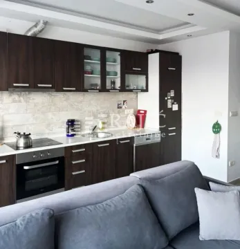 Modern kitchen connected to the living room in a bright interior. - image 2