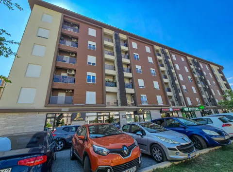 Exterior view of an apartment building with parking in front. - image 2