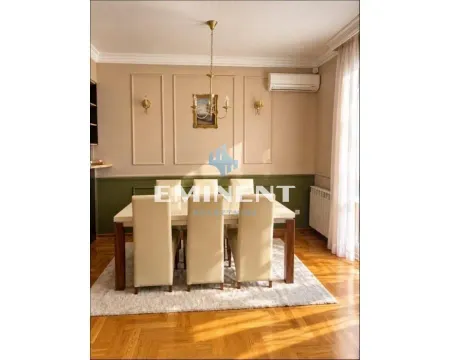Dining area with a table, chairs, and decorative wall moldings. - image 3