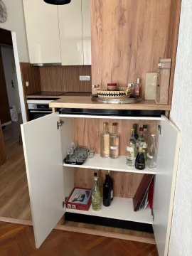Open bar cabinet in a modern kitchen area. - image 4