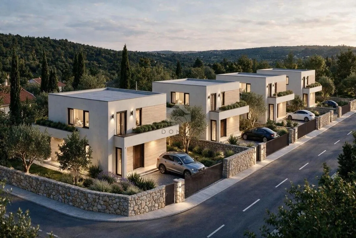 View of a row of modern villas with landscaped yards and parking spaces.
