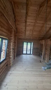 Interior of an unfinished wooden house with wooden walls and floors. - image 12