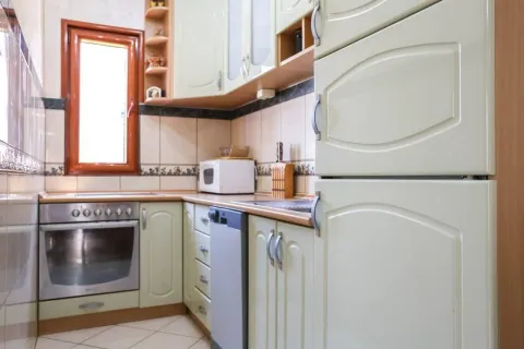 Smaller kitchen equipped with light-toned cabinetry and built-in appliances. - image 5