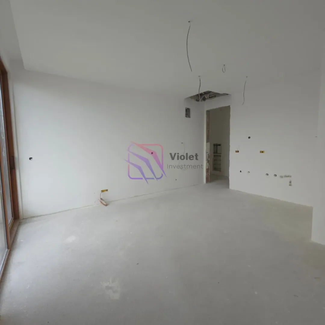 Empty room under construction with white walls.