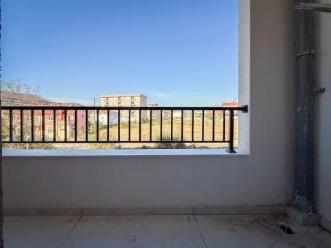 Pogled sa otvorenog balkona na okolne zgrade i pejzaž. - image 5