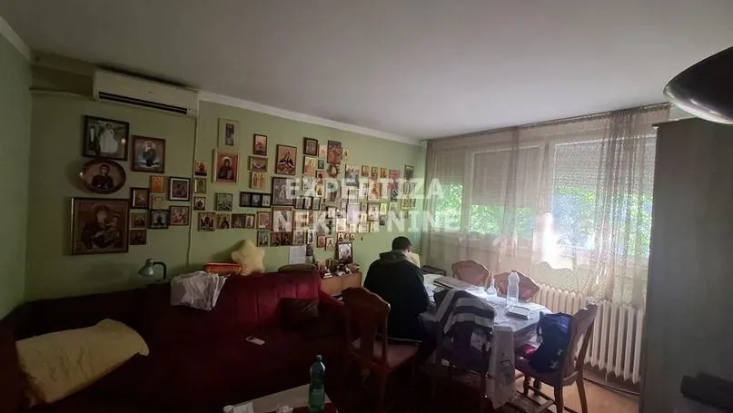 Dnevna soba sa garniturom i trpezarijskim stolom.