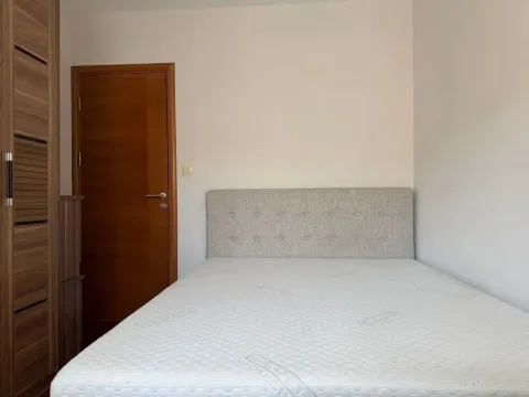 Bedroom with a double bed and a wooden wardrobe. - image 6