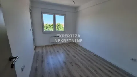 Empty room with laminate flooring and a window. - image 5