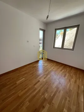 Empty room with hardwood flooring and a window. - image 2