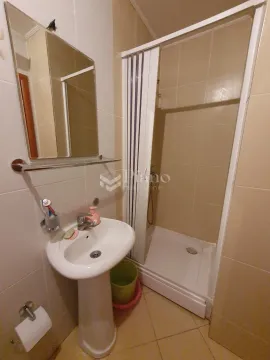Bathroom equipped with a washbasin, mirror, and shower cabin. - image 9