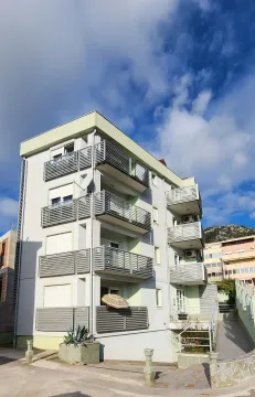 Exterior of a residential building with balconies and a landscaped yard. - image 13