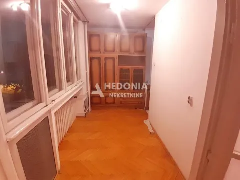 Enclosed balcony with a wooden closet and parquet flooring. - image 4