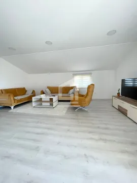 Spacious living room with a sofa set and a TV. - image 14