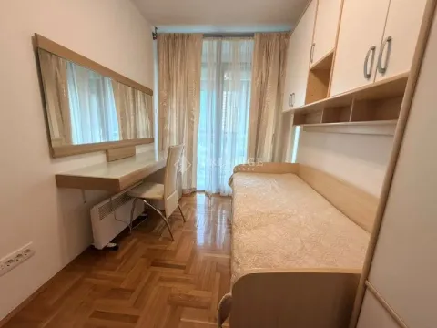 Furnished bedroom with a bed, desk, and large mirror. - image 6