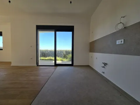 Empty kitchen space with access to the terrace and tiled flooring. - image 4