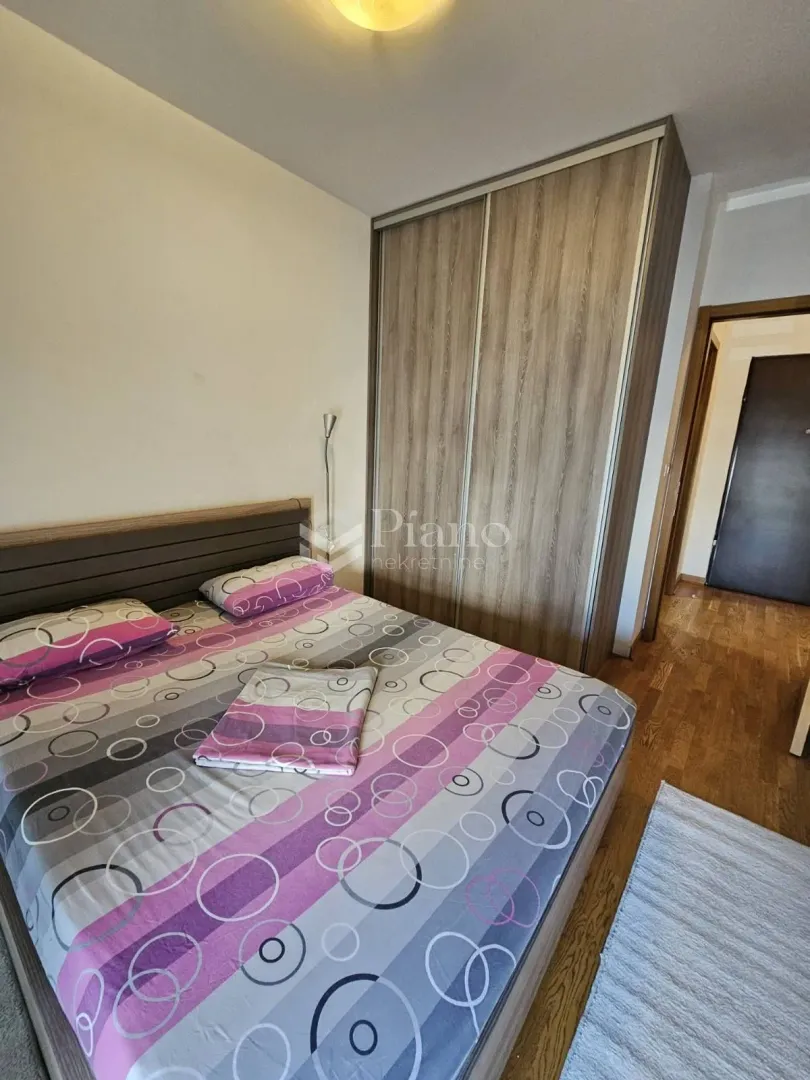Bedroom with a double bed and a fitted wardrobe.