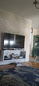 Living room featuring a decorative stone wall and a television. - image 2