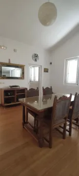 Dining room with a wooden table and chairs. - image 11