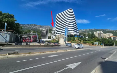 View of a modern multi-story building with surrounding traffic and mountain landscape. - image 5