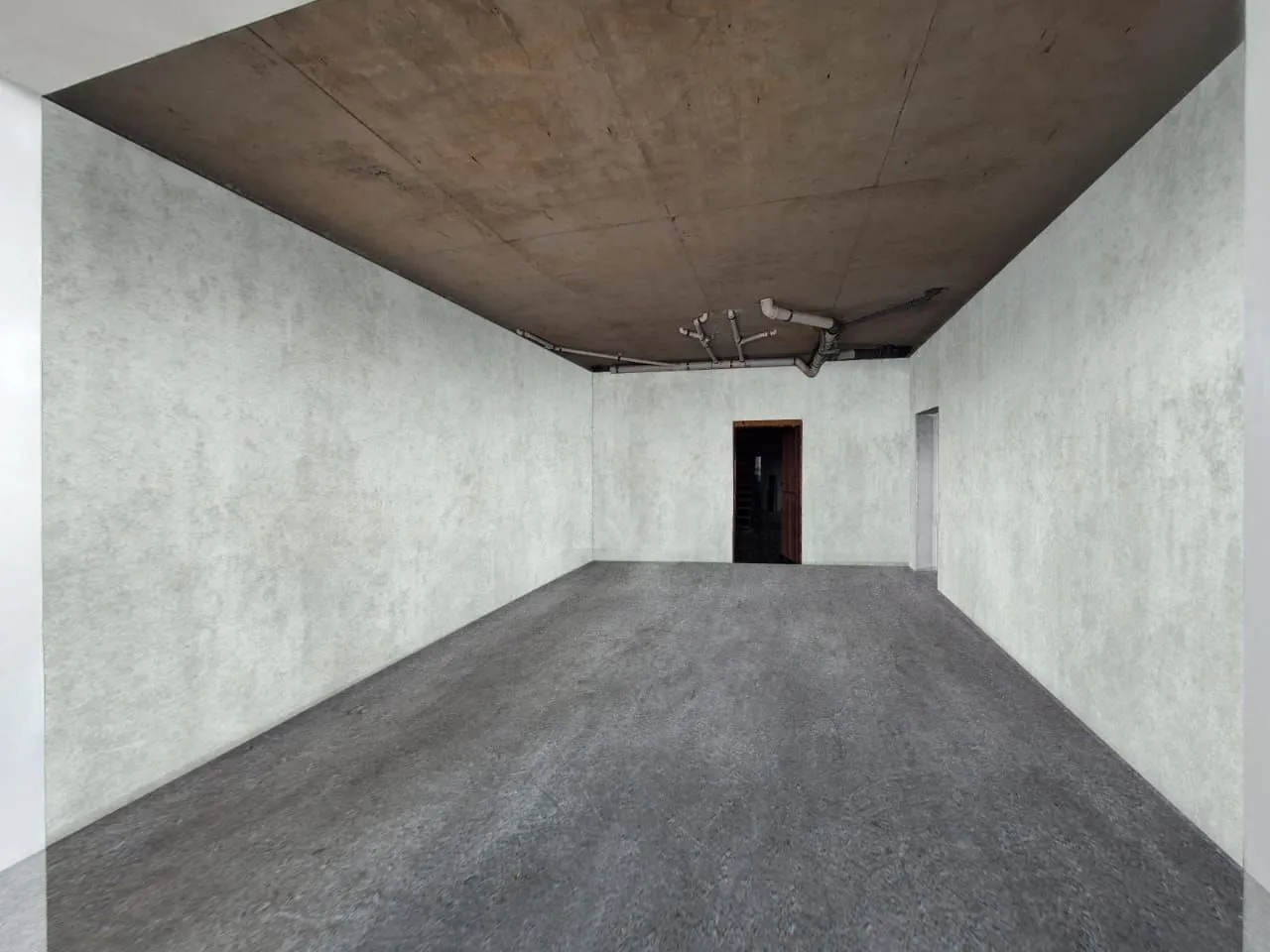 View of an empty room in shell and core condition.