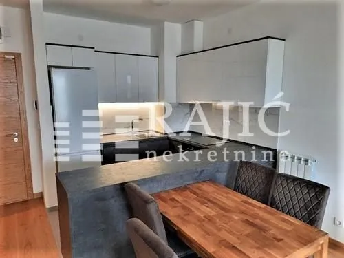 Modern kitchen with a breakfast bar and dining table.