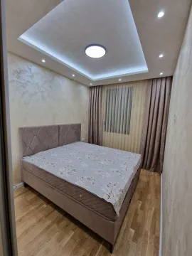 Bedroom with a double bed and modern ceiling lighting. - image 8