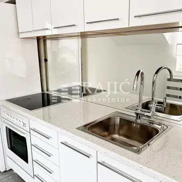Modern white kitchen with built-in hob and sink. - image 14