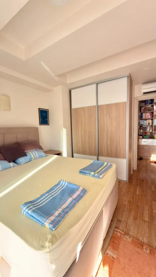 Bedroom with a double bed, wardrobe, and a view of the hallway.
