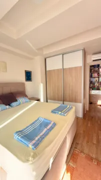 Bedroom with a double bed, wardrobe, and a view of the hallway. - image 10