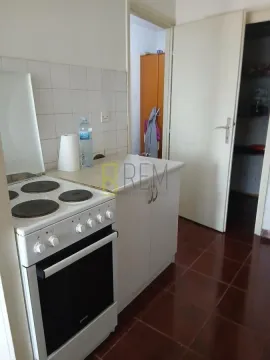 Smaller kitchen with a stove and cabinets. - image 6