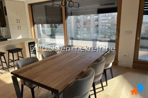 Dining area with a large wooden table and chairs as part of the living room. - image 6