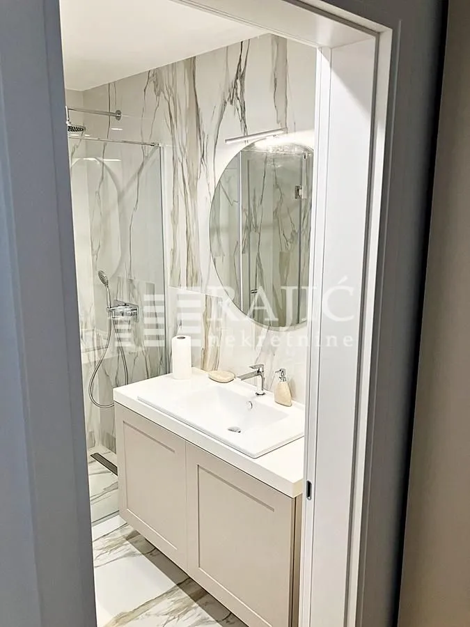 Modern bathroom equipped with a vanity and walk-in shower.