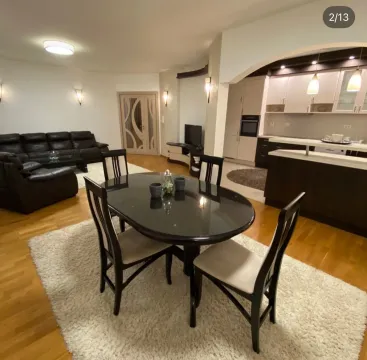 Living room with dining area and open-plan kitchen. - image 2
