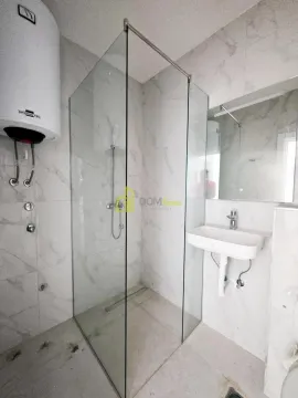 Bathroom with a shower cabin, washbasin, and water heater. - image 3