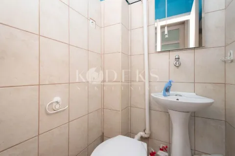 Small tiled bathroom with a washbasin and toilet. - image 12