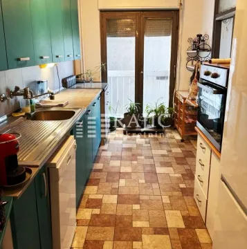 Small kitchen with green cabinets and access to the terrace. - image 5