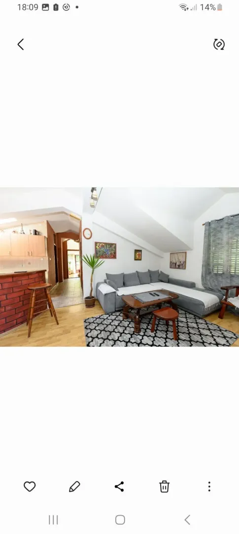 Living room with a sofa set and a view of the kitchen.