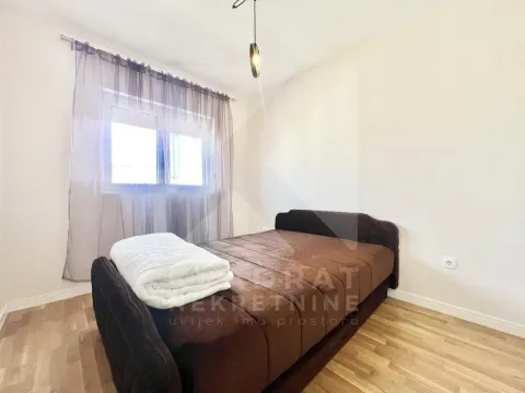 Bedroom with a double bed and a window with curtains. - image 5