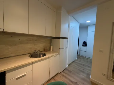 Smaller kitchen with white cabinetry and a sink. - image 3