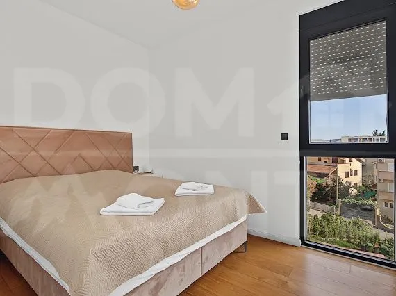 Bedroom with a double bed and a large window overlooking the surroundings.