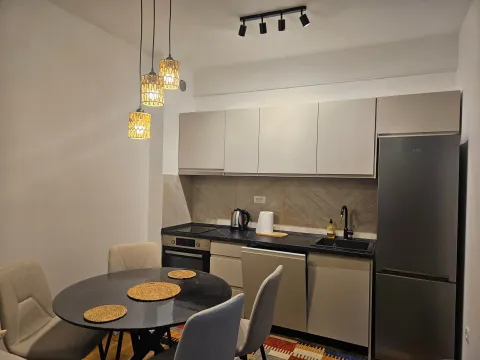 Modern kitchen with dining table and built-in appliances. - image 2