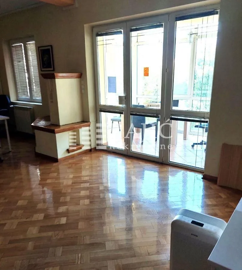 Spacious living room with wooden flooring and large glass balcony doors.